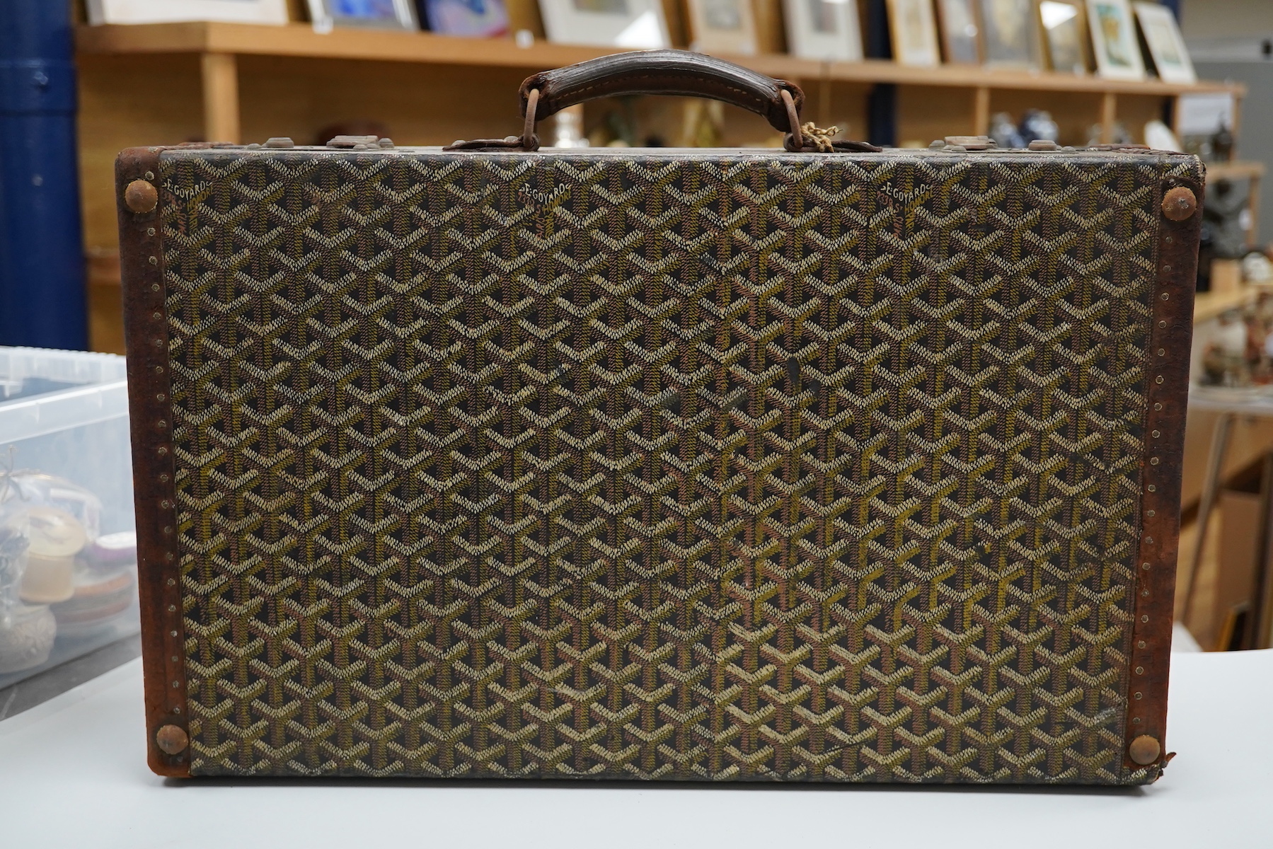 A vintage Malles Goyard suitcase with all over printed design, applied metal label to the exterior, height 13cm, width 49cm, depth 30cm